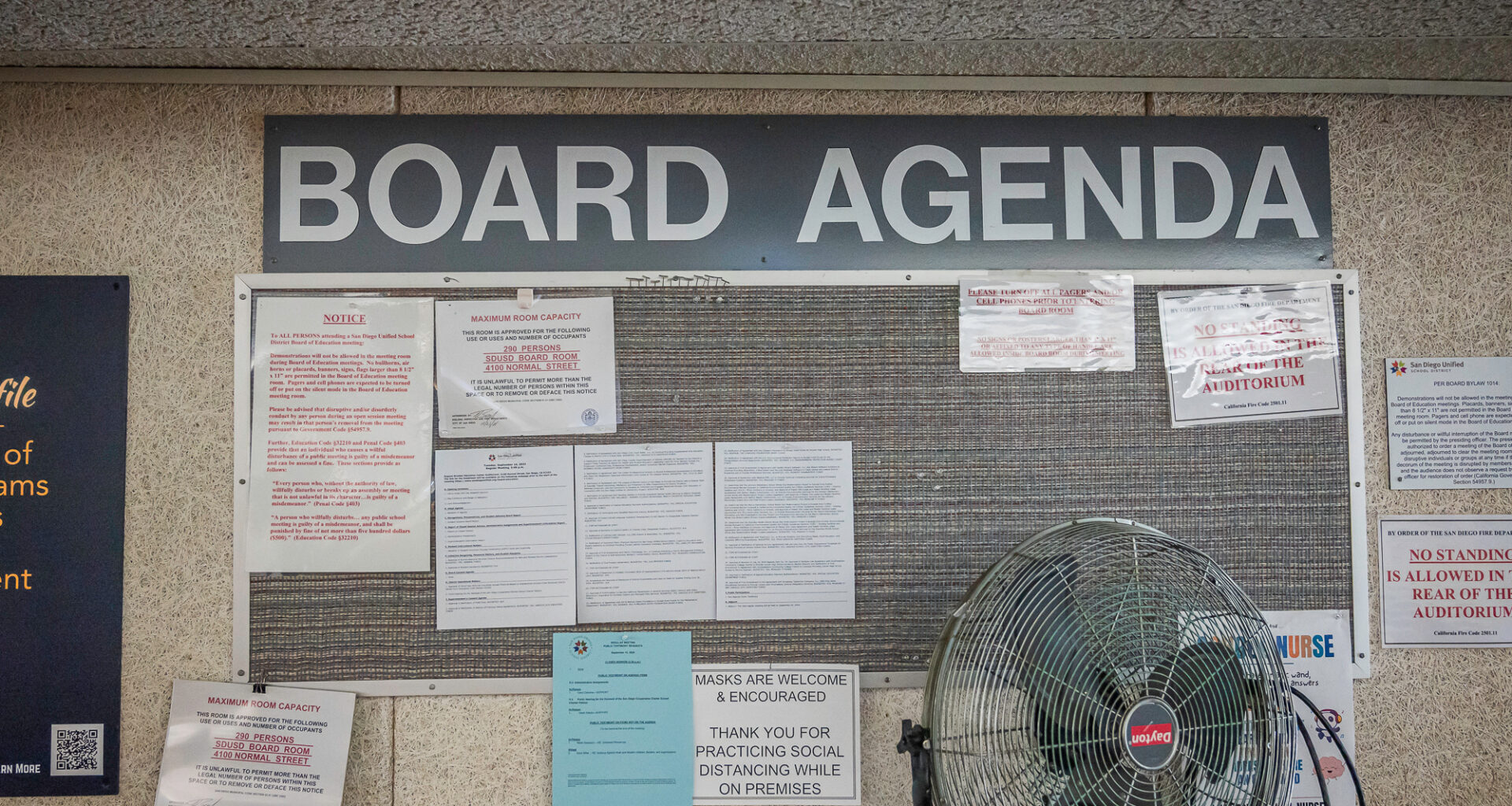 A bulletin board at the San Diego Unified School District Board of Education's Eugene Brucker Education Center Auditorium in San Diego on Tuesday, Sept. 10, 2024. / Photo by Vito di Stefano for Voice of San Diego