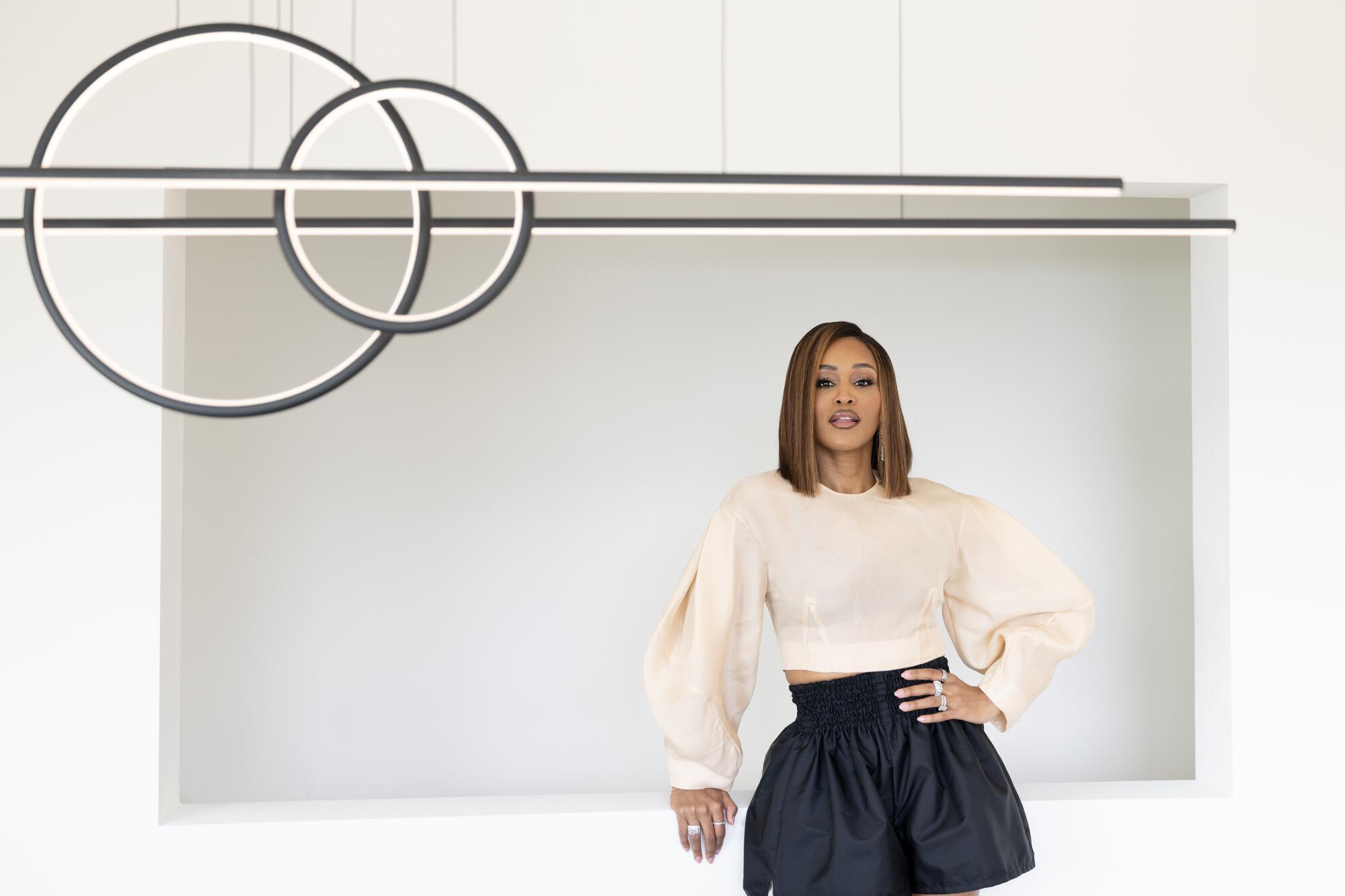 Black woman in a black skirt and flowy white top