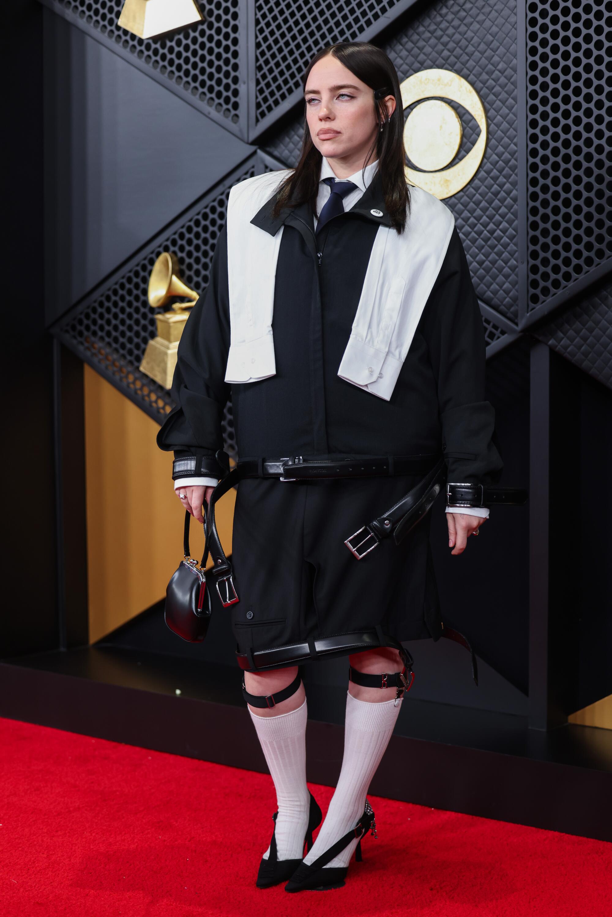 Billie Eilish poses on the Grammys red carpet. 
