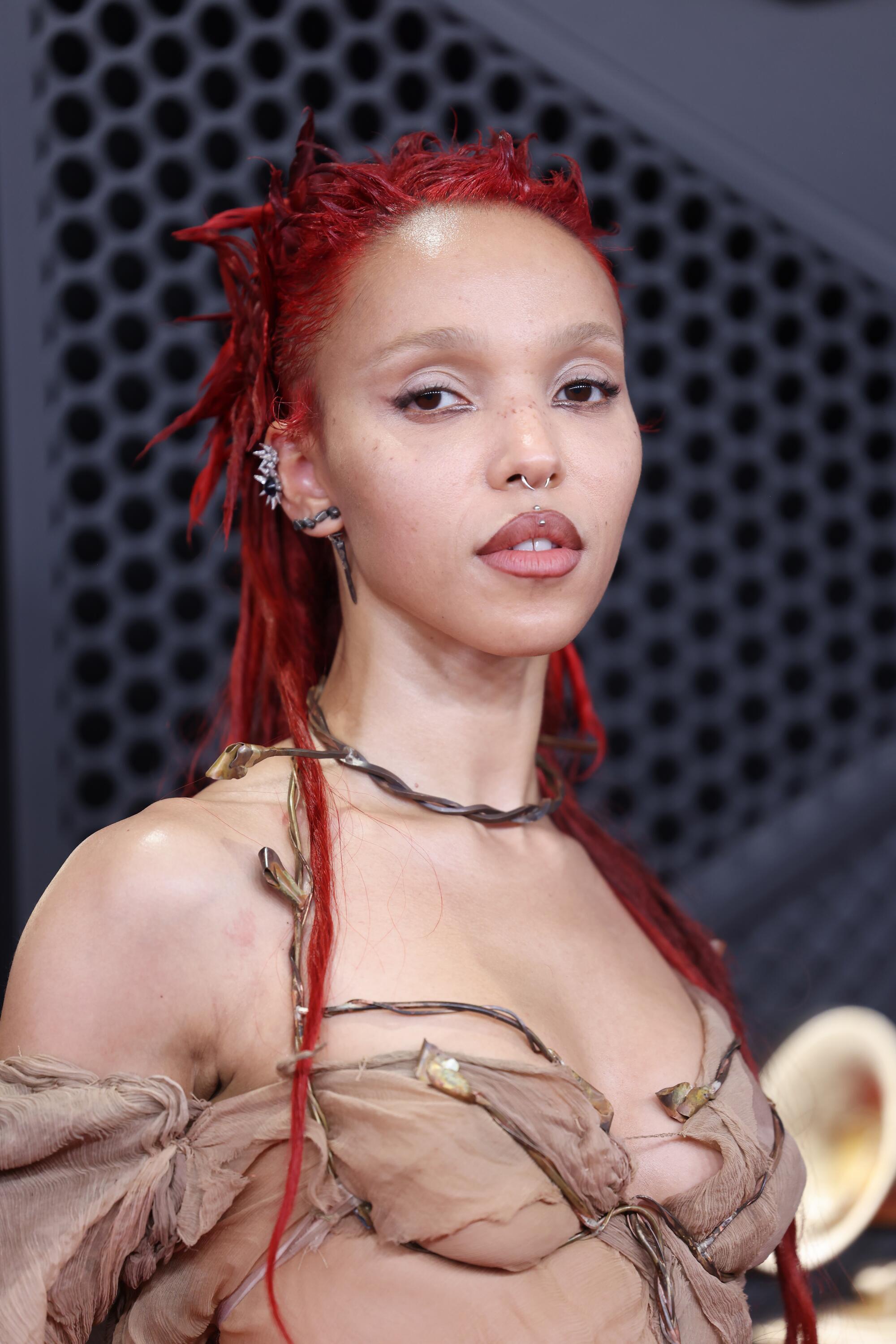 FKA Twigs poses on the red carpet. 