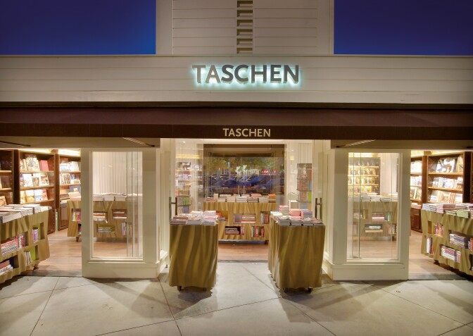 A picture of the front of a bookstore, the sign says "Taschen."