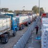Trucks carrying humanitarian aids line up to enter the Egyptian gate of the Rafah crossing, heading for inspection by Israeli authorities before entering the Gaza Strip, in Rafah, Egypt, Sunday, Feb. 1, 2026.