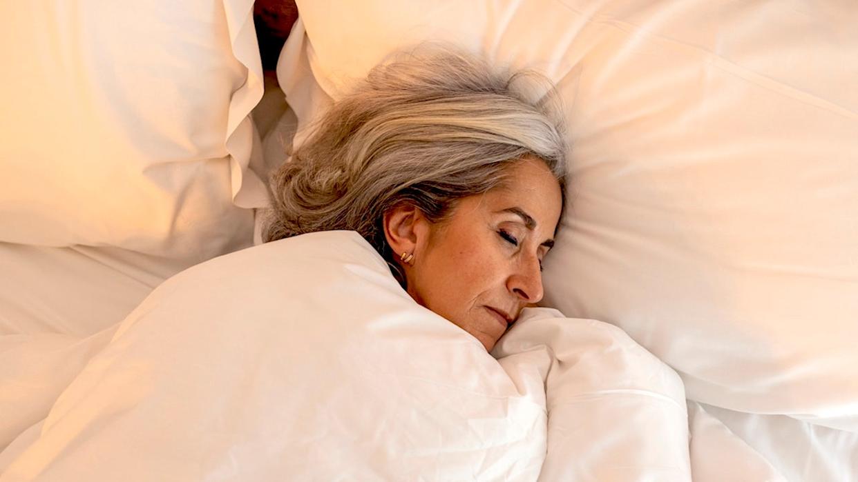 Older woman sleeping in bed