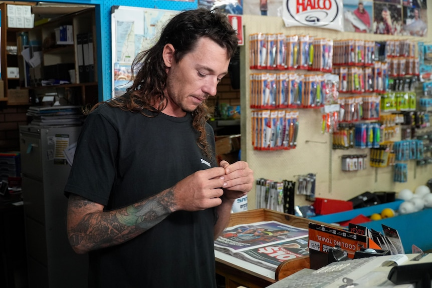 Steve eley fidgets with something small in his hand. 