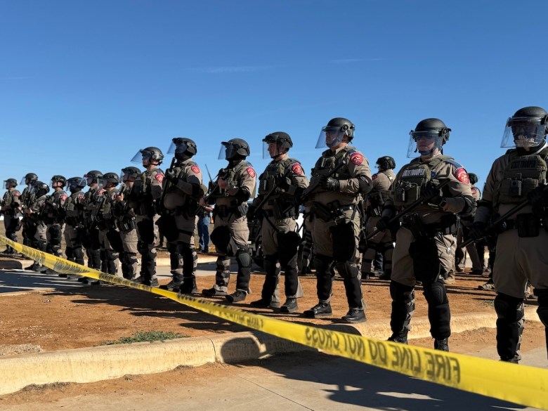 DPS troopers stand guard in front of the Dilley detention center during a protest last weekend.