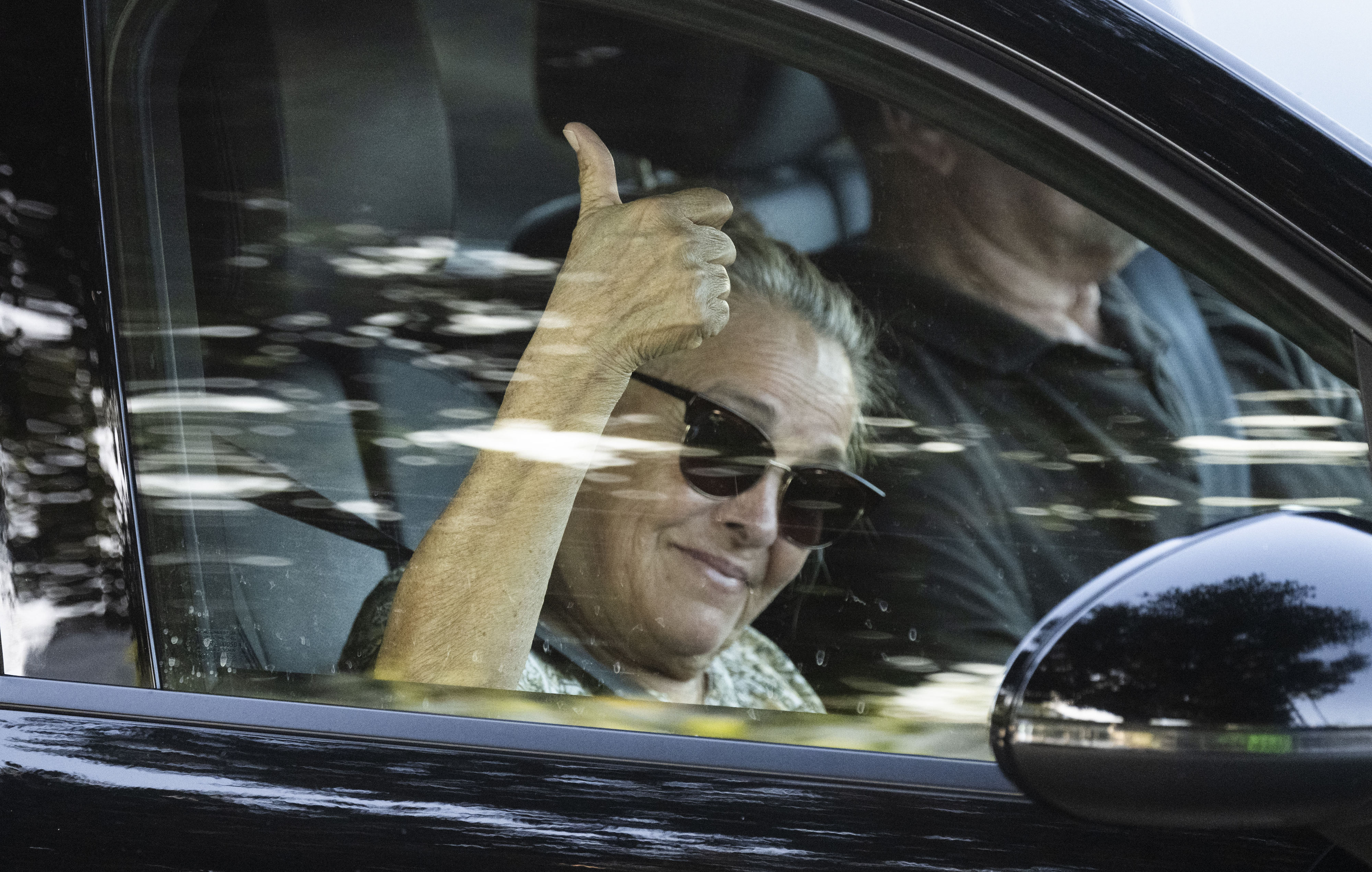 A passing motorist gives the thumbs up to protesters at...