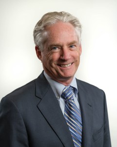 headshot of a man smiling