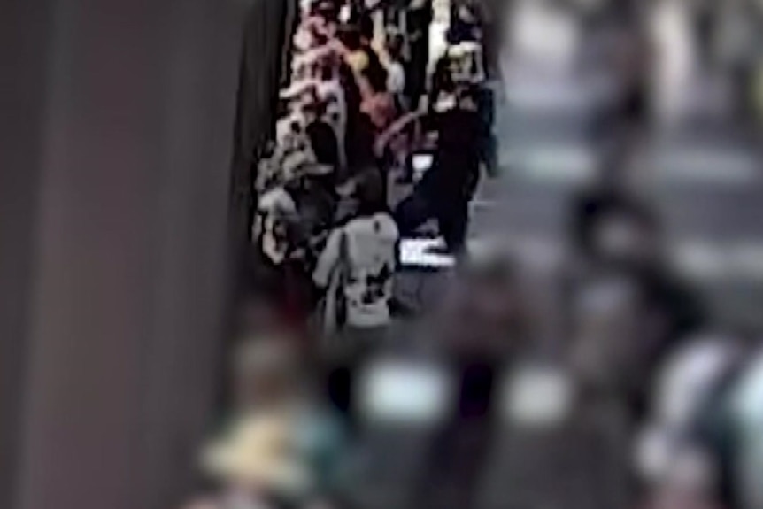 A man in a black outfit preparing to throw an object.