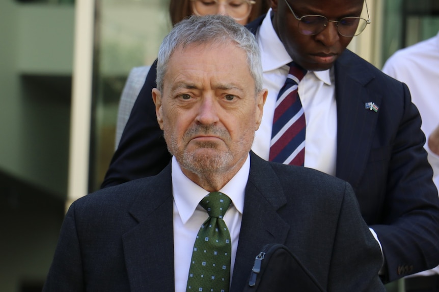 A front-on shot of  lawyer Jonathan Davies leaving court. 