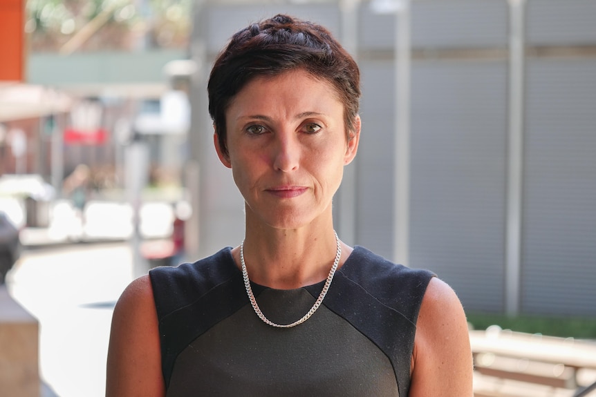 A woman with short hair looking directly at the camera.