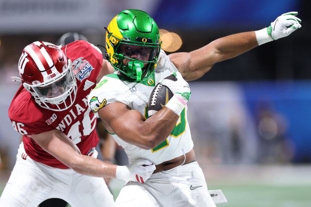 ATLANTA, GEORGIA - JANUARY 09: Kenyon Sadiq #18 of the Oregon Ducks is tackled by Isaiah Jones #46 of the Indiana Hoosiers during the first quarter in the 2025 College Football Playoff Semifinal at the Chick-fil-A Peach Bowl at Mercedes-Benz Stadium on January 09, 2026 in Atlanta, Georgia. (Photo by Kevin C. Cox/Getty Images)