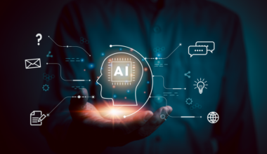 A glowing digital head with AI written inside it floats above a human hand.