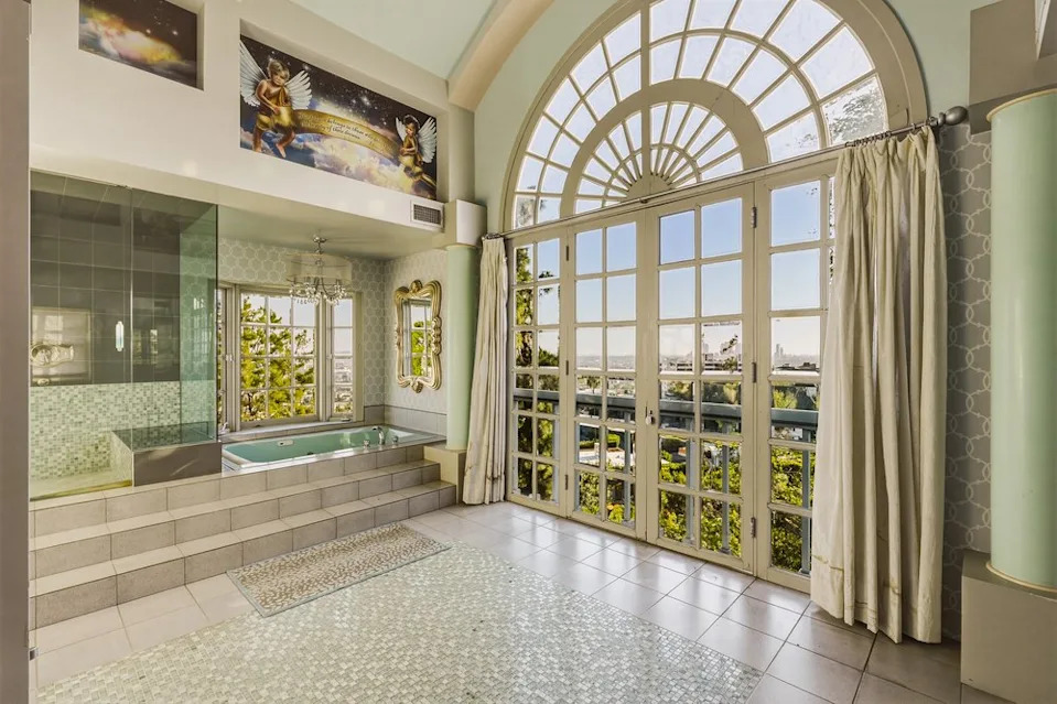 A bathroom with cherub paintings on the wall in Richard Simmons' Estate in California