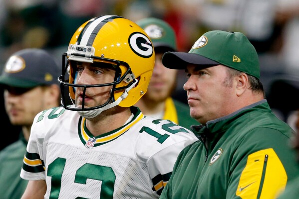 Green Bay Packers quarterback Aaron Rodgers (12) talks with Green Bay Packers head coach Mike McCarthy prior to an NFL football game against the Arizona Cardinals, Dec. 27, 2015, in Glendale, Ariz. (AP Photo/Ross D. Franklin, File)