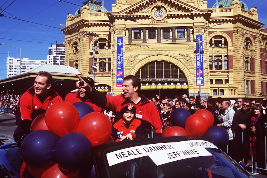 Neale Daniher rides in a convertible during the 2000 AFL grand final parade on Flinders Street.