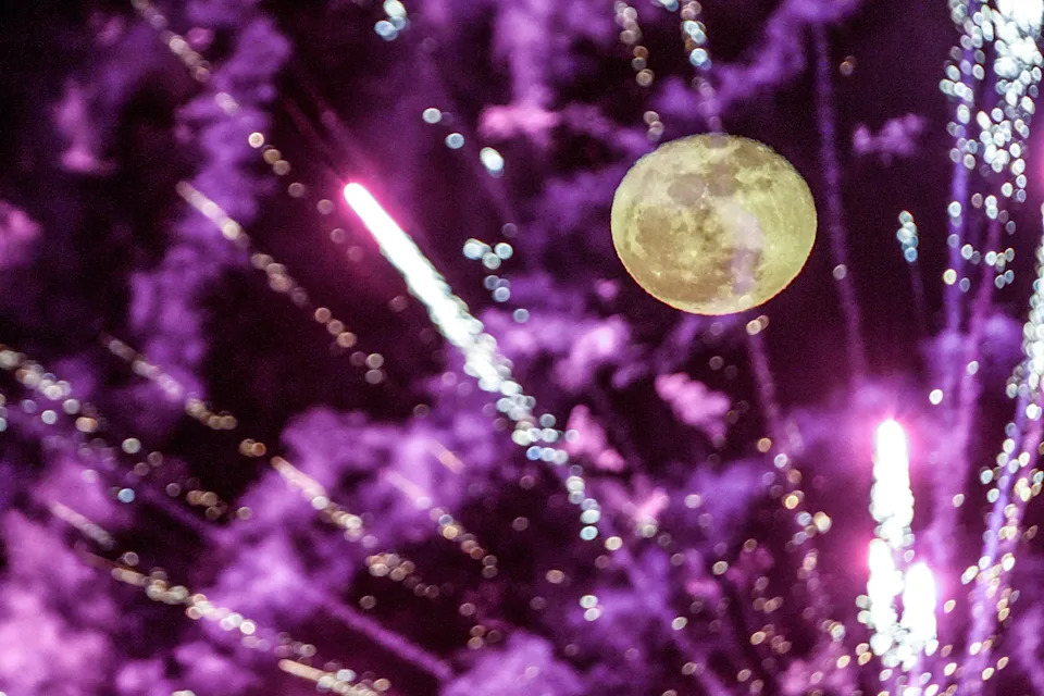 Postgame fireworks blast in the air with a moon, one day after the Pink full moon, after the season opening game at Fifth Third Park in Spartanburg, South Carolina, on Friday, April 3, 2026.