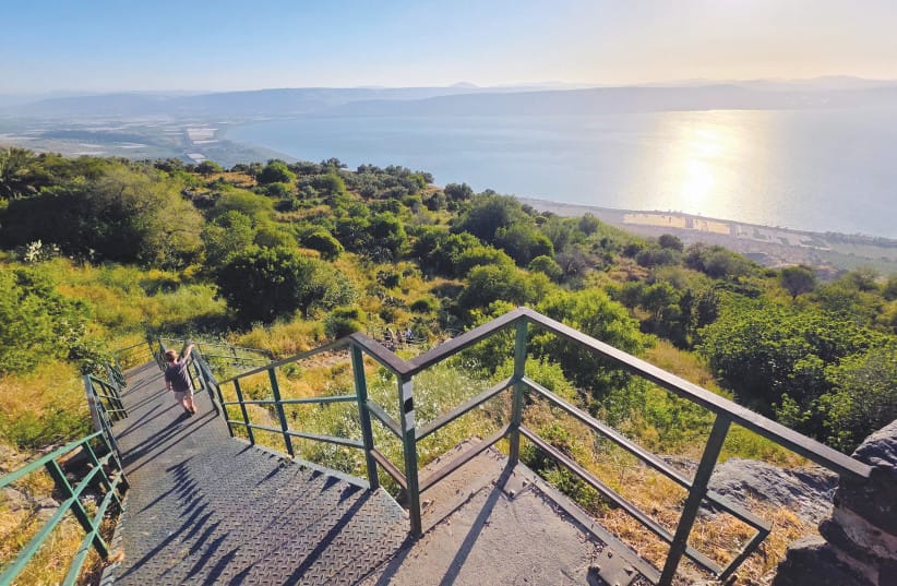 The Descent: A staircase winds downward from the resort complex, leading directly into the unscripted terrain of the plateau as sunset colors gather over the lake.
