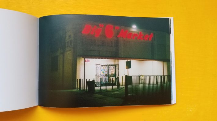 A zine opened to a page on a yellow background.