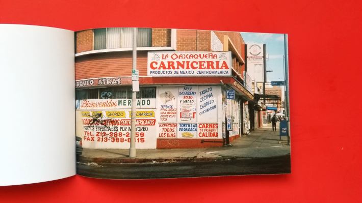 A zine opened up to a page on a red background.