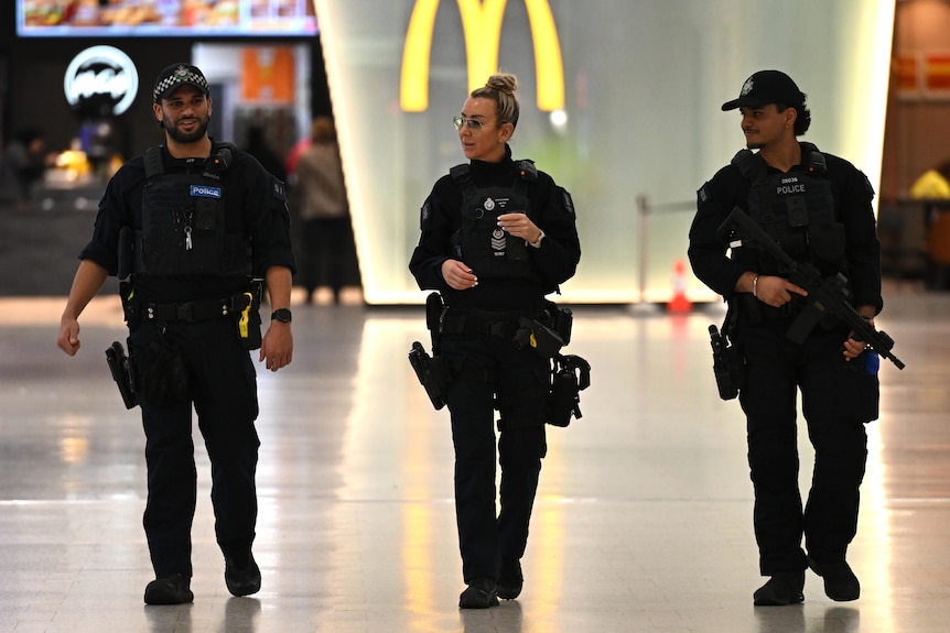 Armed AFP officers at Sydney Airport.