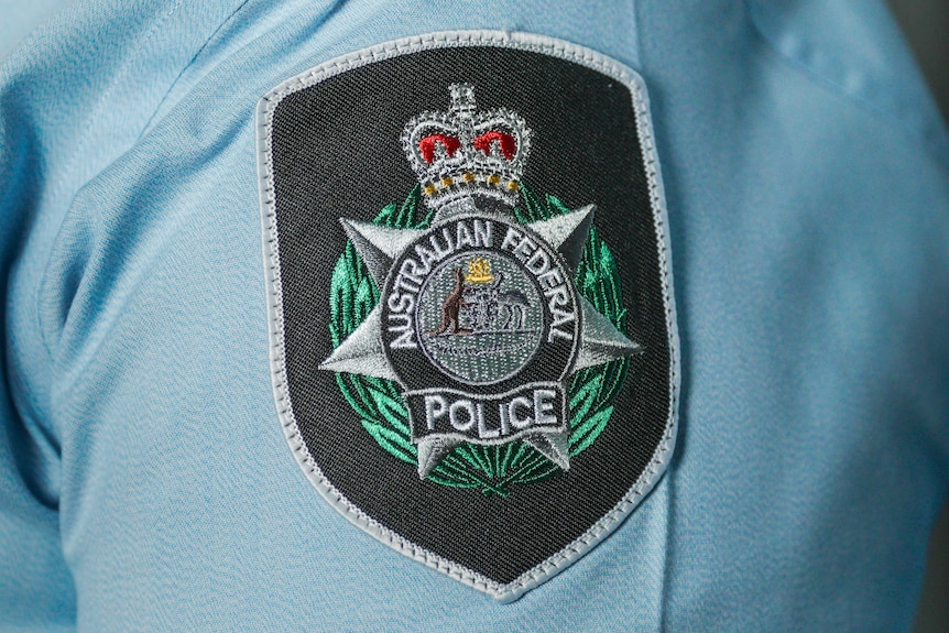 An Australian Federal Police shoulder Insignia on a Blue Uniform shirt
