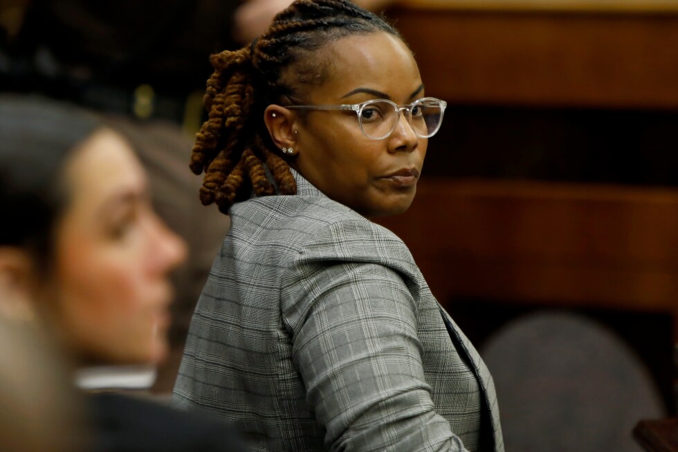 Ex-official accused of ignoring warnings student had gun faces trial