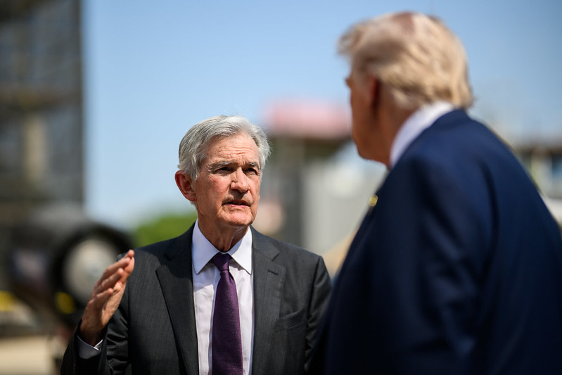 Fed Chair Jerome Powell about to shake President Donald Trump's hand.