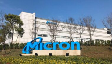 Micron company logo in front of a company building.