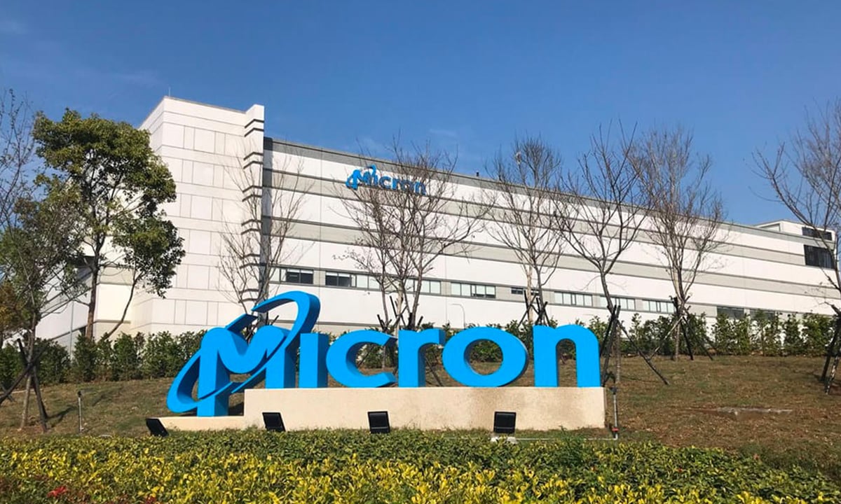 Micron company logo in front of a company building.