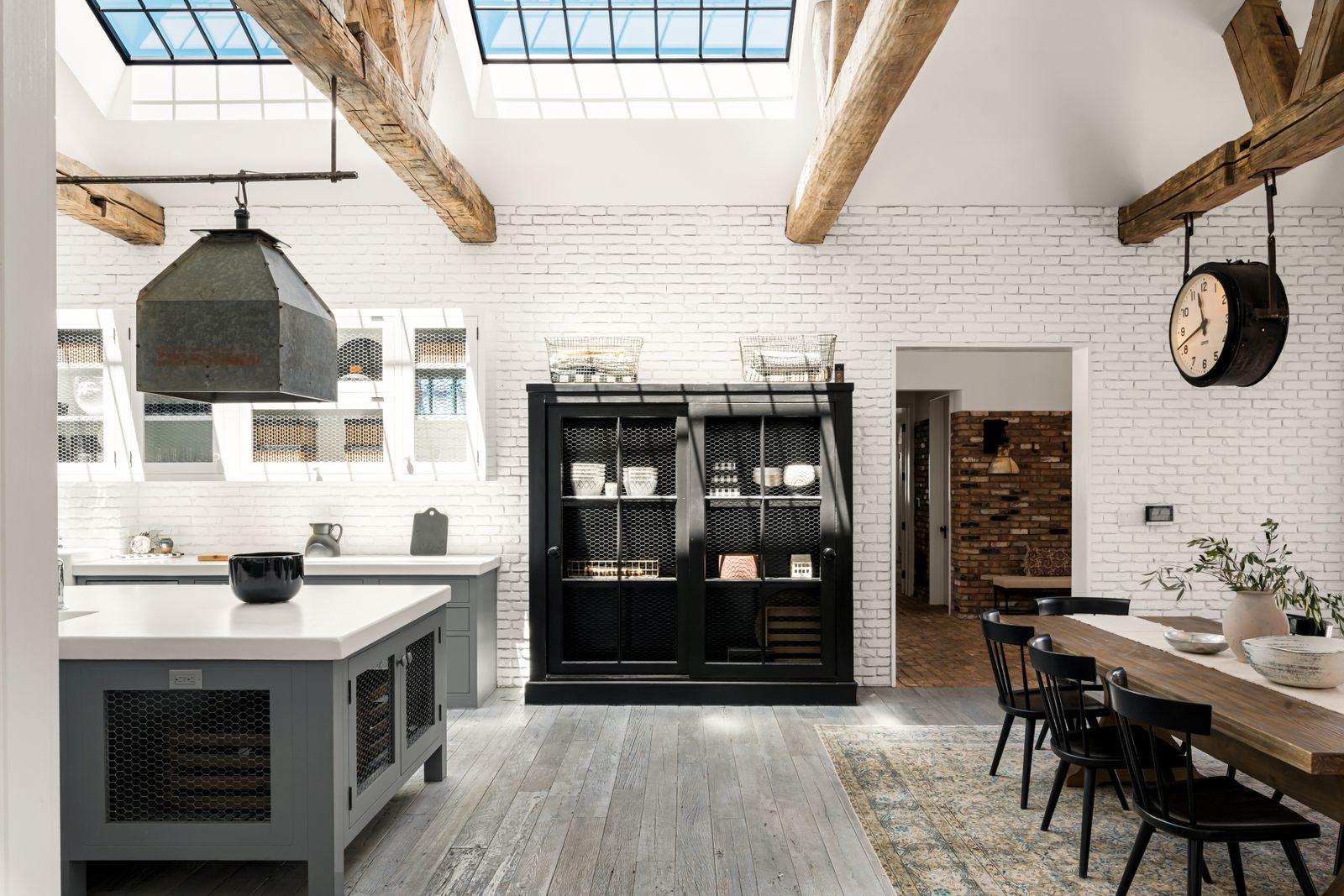 kitchen of Diane Keatons former home with skylights vaulted ceiling wood beams along ceiling gray floor gray kitchen...