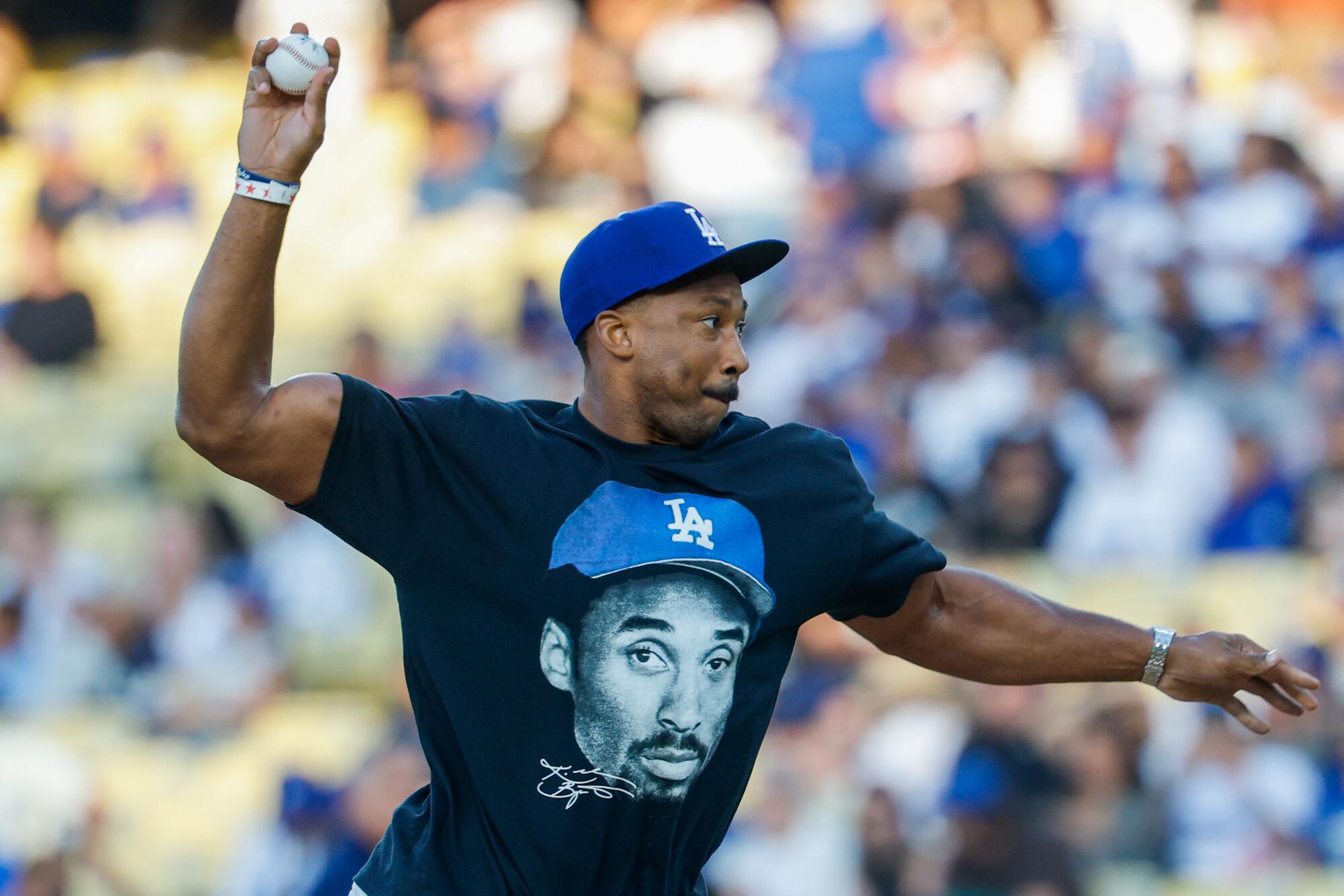 Rams defensive end Myles Garrett throws out the ceremonial first pitch Saturday at Dodger Stadium.
