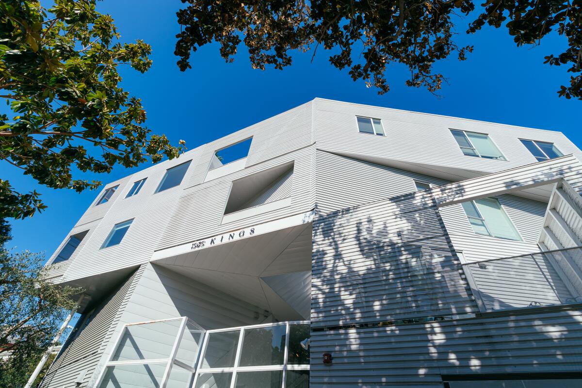The exterior of a four-story white architectural condo