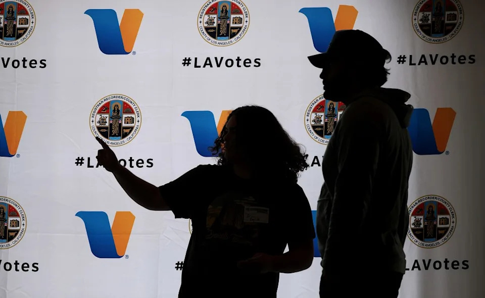 A polling worker helps direct a voter, right, at Beverly Hills City Hall on Tuesday, June 2, 2026. Los Angeles Times via Getty Images