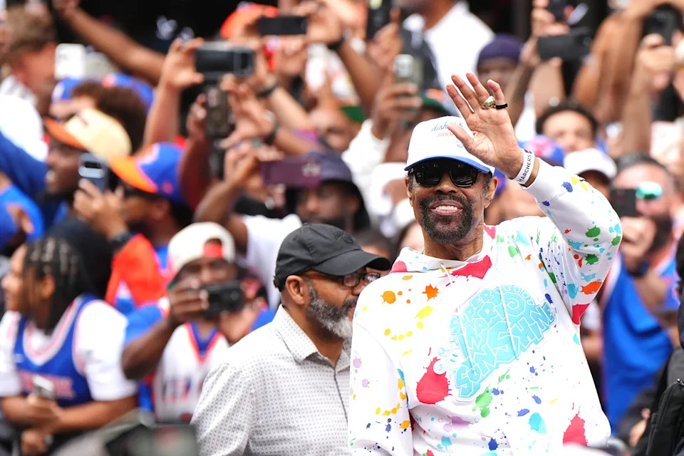 Knicks legend Walt "Clyde" Frazier waves to the crowd during the parade.