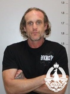 A mugshot of a man with brown hair wearing a serious facial expression.