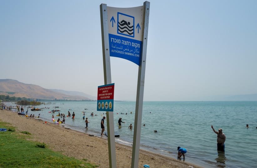 Israelis enjoy the last days of the summer. holiday on an extremely hot day at Duga Beach, on the eastern shores of the Sea of Galilee on August 30, 2022.