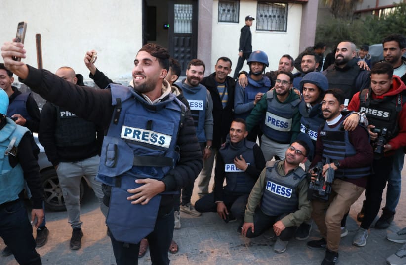 Moaz Abu Taha, a Palestinian journalist who had worked with some Palestinian and international outlets, takes a selfie with fellow journalists in Khan Yunis in the southern Gaza Strip on January 18, 2025.