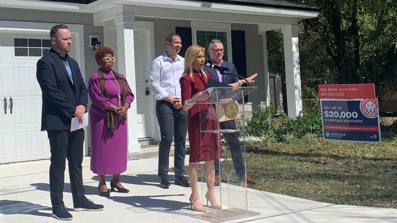 Jacksonville Mayor Donna Deegan stands at a lectern and announces an affordable housing program.