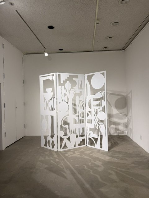 Heavy Metal exhibition installation featuring a white cut-metal sculptural screen casting intricate shadows at LAMAG in Barnsdall Art Park.