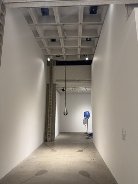 Hanging sculptural installation suspended in a gallery corridor at Heavy Metal exhibition in Los Angeles.