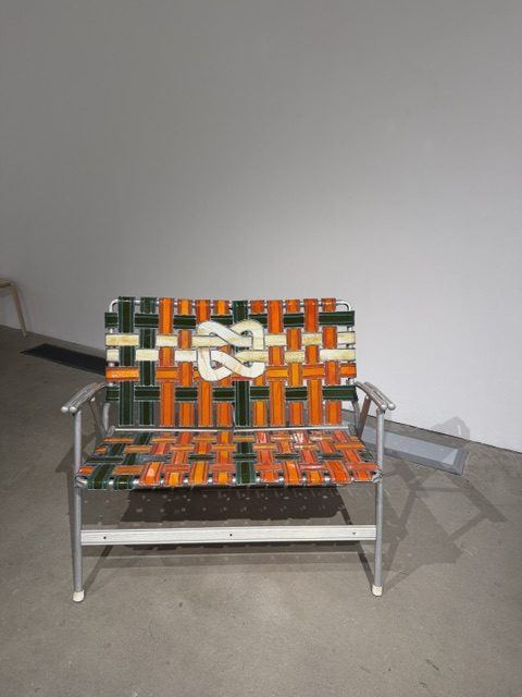 Colorful woven sculptural bench combining metal framing and textile-inspired patterns in Heavy Metal.