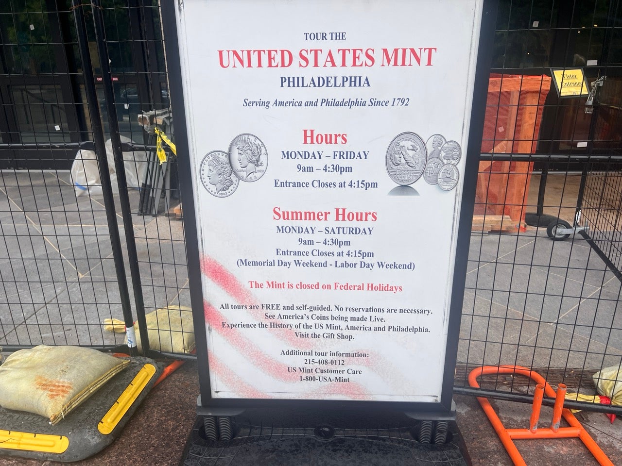 A sign with the hours listed for the United States Mint.