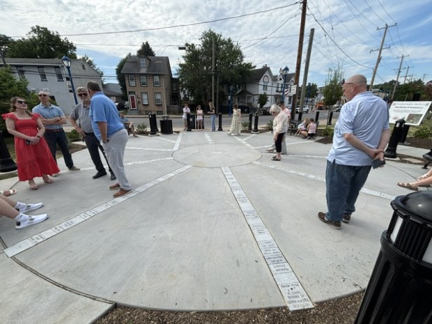 People walk around and look at the bricks that were displayed in a rounded seating area next to the Phoenix Wheel. (Photo by Barry Taglieber - For MediaNews Group)