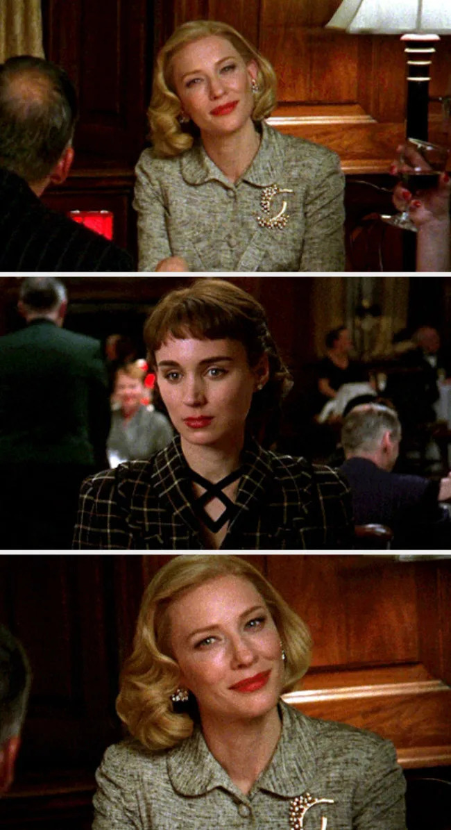 Carol and Therese looking at each other lovingly in a restaurant
