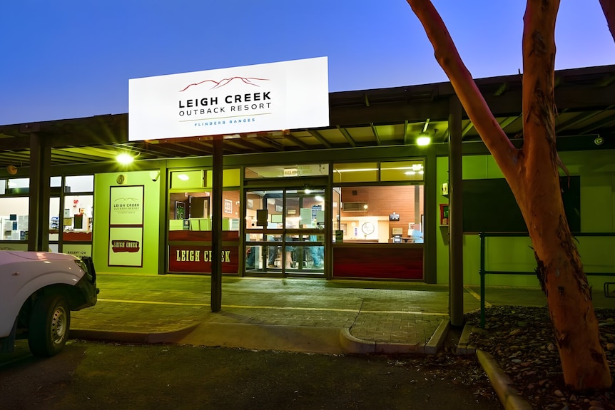 A one-storey building saying Leigh Creek Outback Resort, pictured at night.