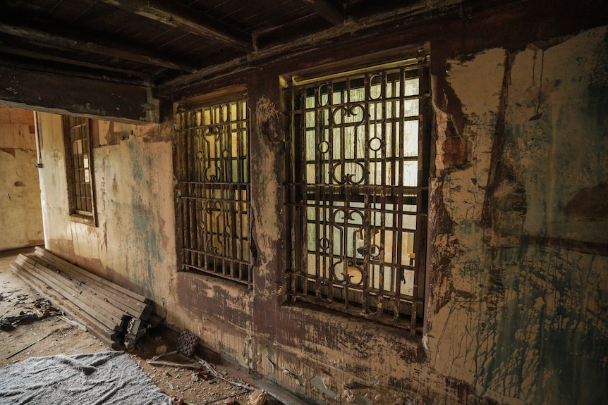 A worn down interior of an older brick building.