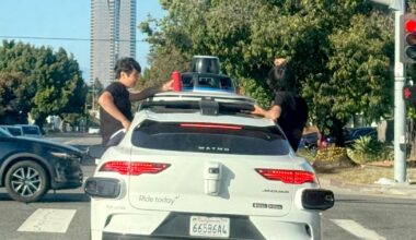 Teens sit in windows as Waymo travels through Westside