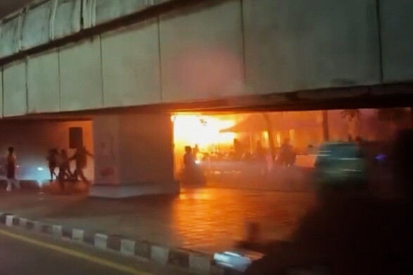 In this image made from video provided by Instagram handle @jackfanchan, people move around a fire at a bar in Bangkok, Thailand, Monday, July 13, 2026. (@jackfanchan via AP)
