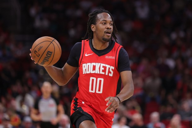 HOUSTON, TEXAS - APRIL 12: Tristen Newton #00 of the Houston Rockets brings the ball up court against the Memphis Grizzlies during the second half at Toyota Center on April 12, 2026 in Houston, Texas. NOTE TO USER: User expressly acknowledges and agrees that, by downloading and or using this photograph, User is consenting to the terms and conditions of the Getty Images License Agreement. (Photo by Alex Slitz/Getty Images)