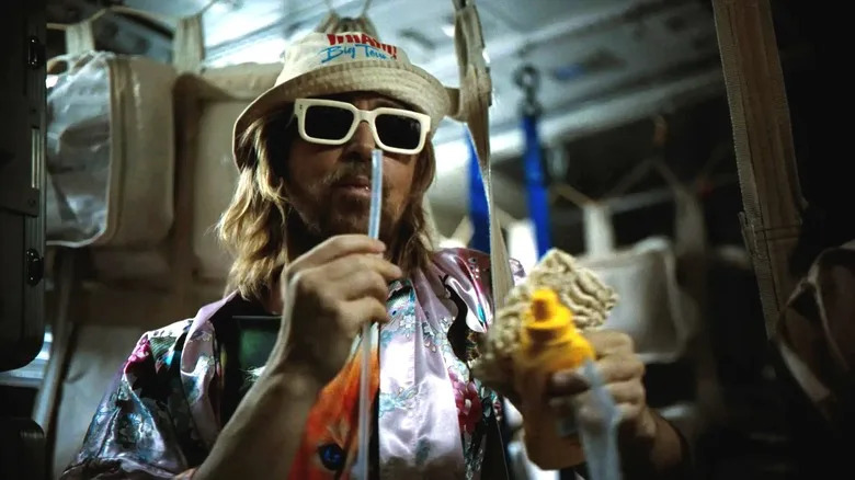 Ryan Gosling as Ryland Grace drinking and eating ramen with mustard in Project Hail Mary